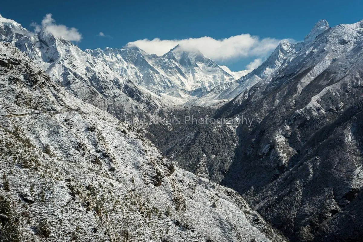 A snowy mountain ridge with a faint watermark that is almost invisible