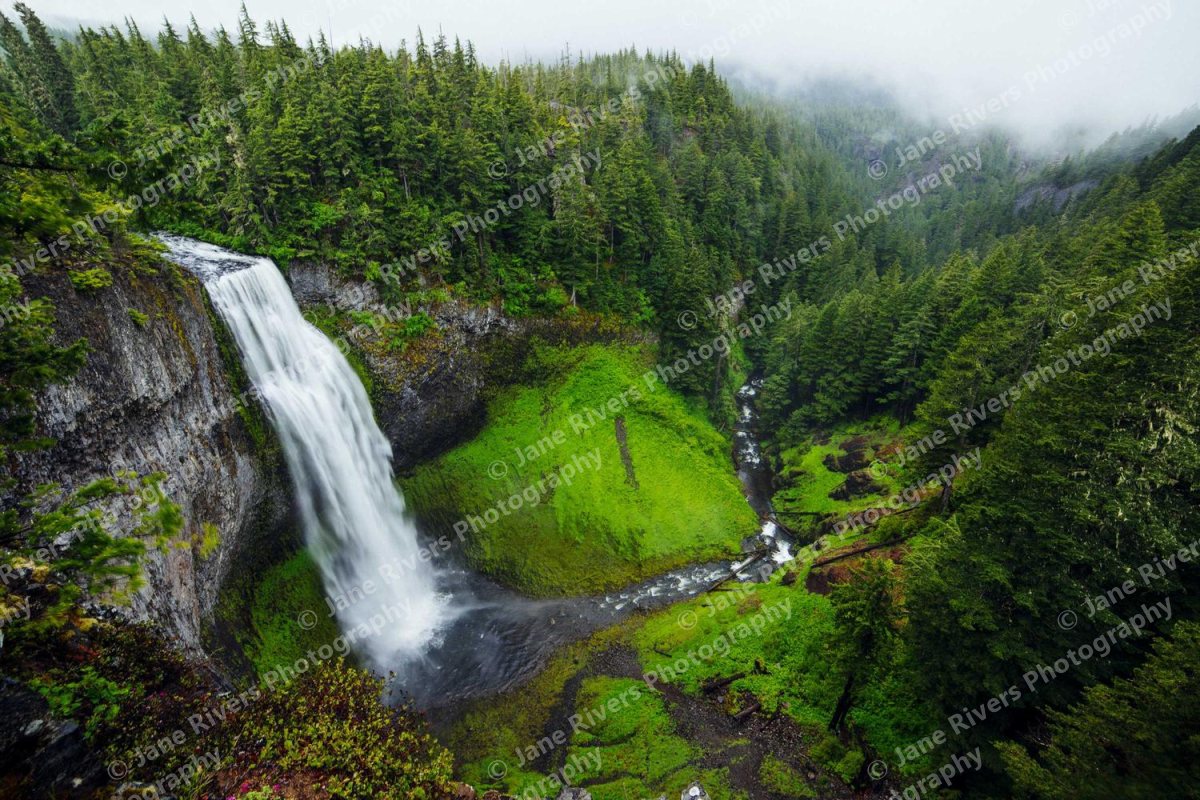 A waterfall photo with a small watermark repeated in a tiled pattern across the whole image
