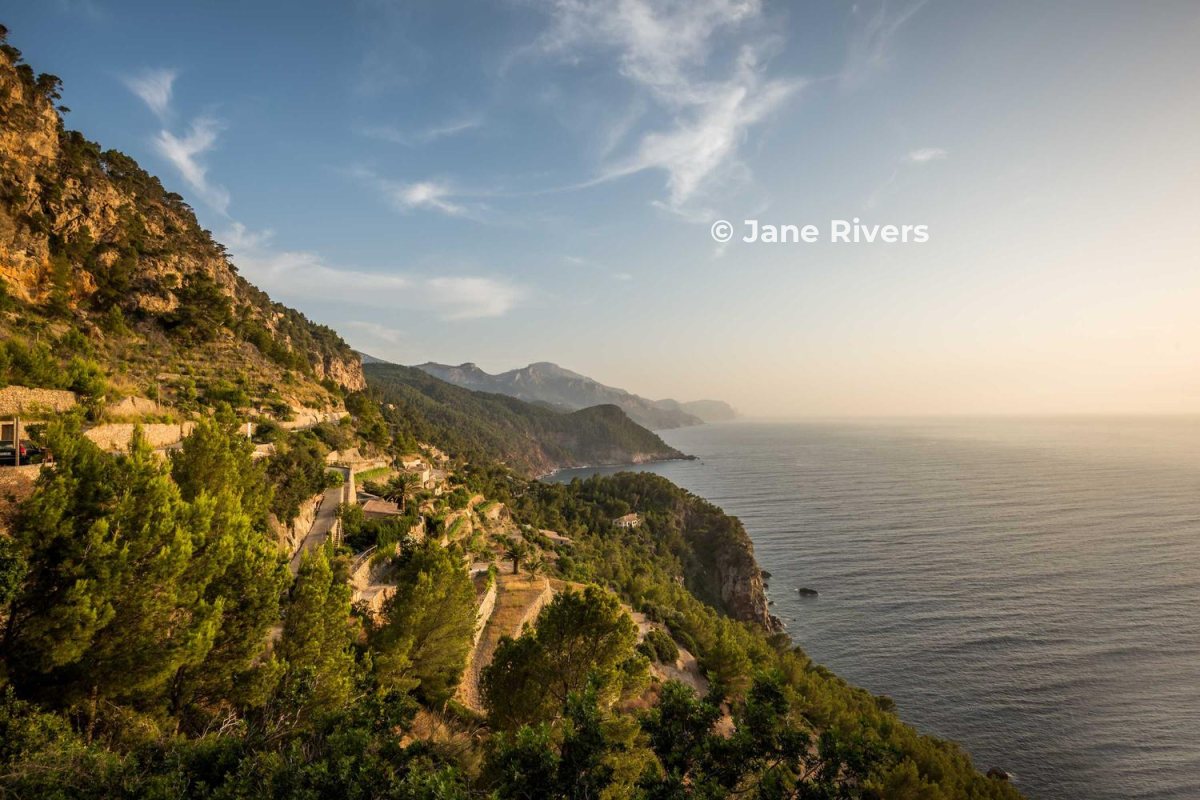 A coastal view with a small copyright watermark in the clear evening sky