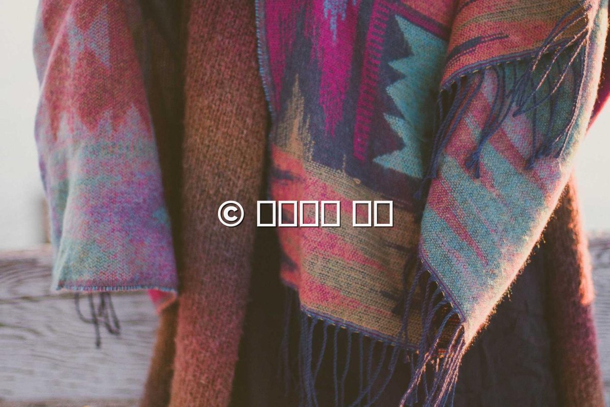A textile photo where a Japanese name is shown as empty boxes because the font lacks those characters