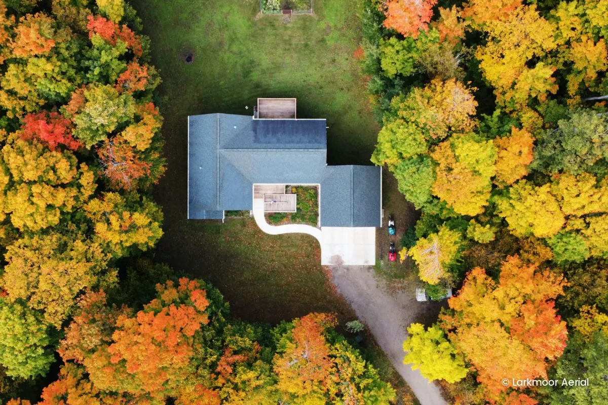 The same house photo with no tiled pattern, only a small © Larkmoor Aerial credit in the lower right corner