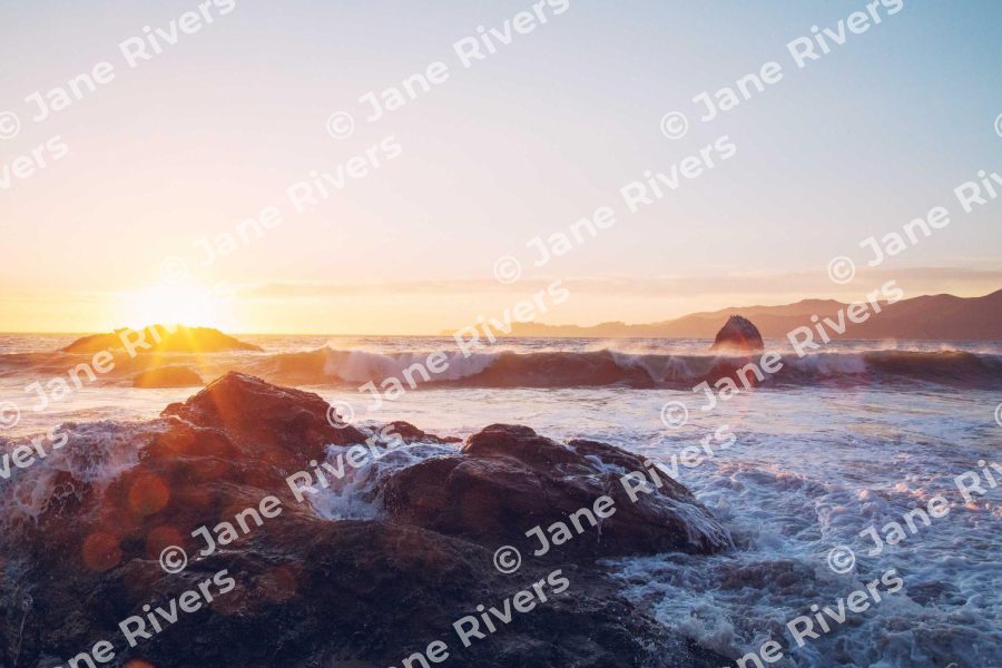 A sunset seascape covered in a heavy tiled watermark