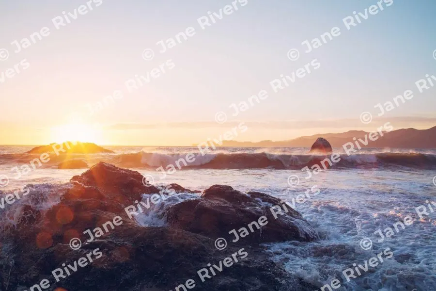A sunset seascape covered in a heavy tiled watermark