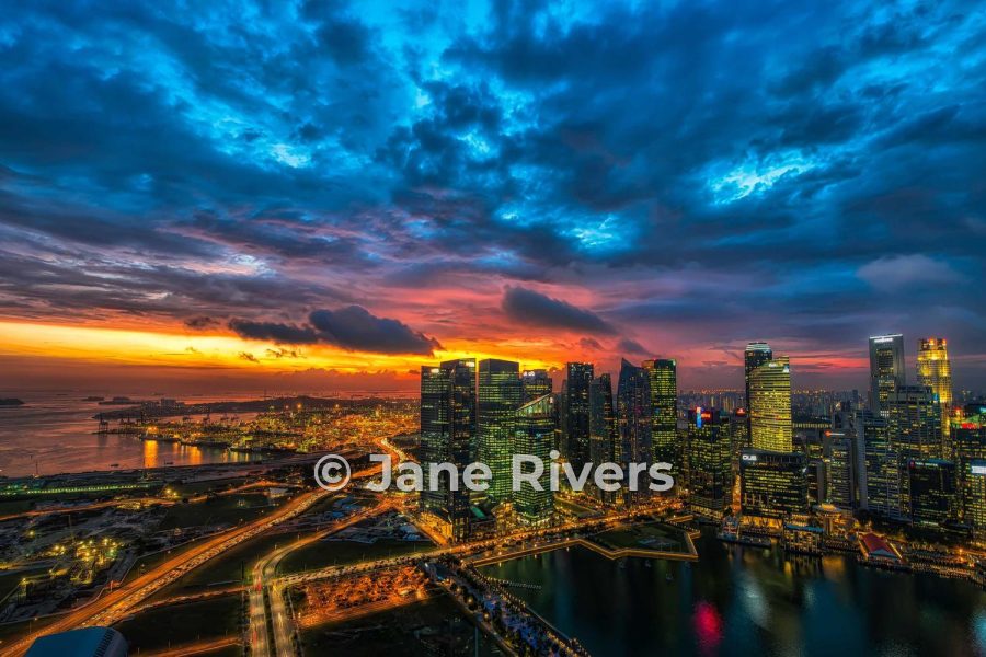 A city skyline at dusk with a medium watermark in the lower third