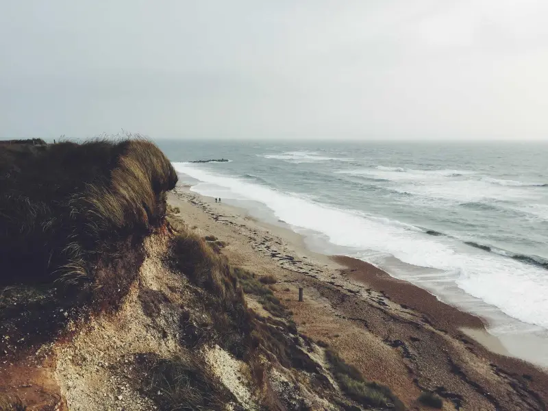 A coastal cliff above the sea with a protection pattern over the whole photo